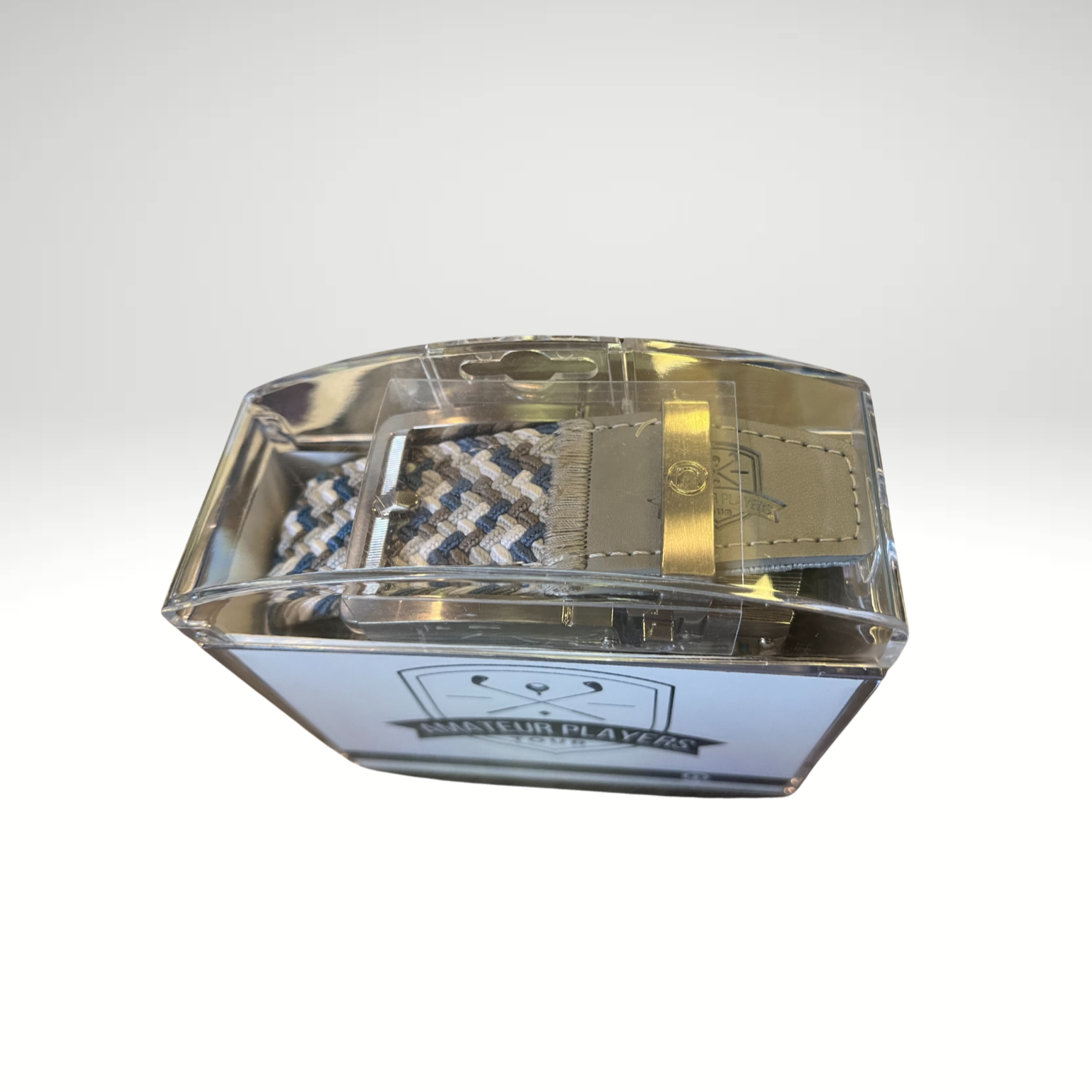 A braided golf belt, featuring a tricolor design and stamped APT logo.